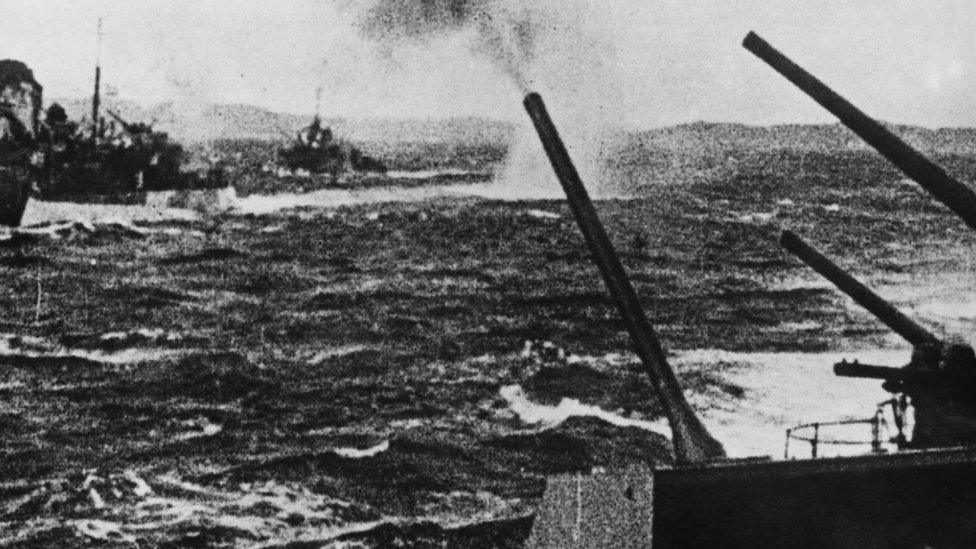 Soviet warships fire their anti-aircraft guns in defence of an Allied convoy, which is being attacked by German aircraft near a Russian port in the Arctic, 4th May 1943