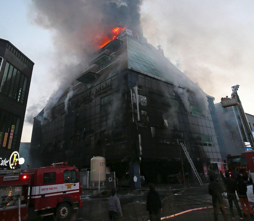 Flames and smoke billow from an eight-storey building after a fire broke out in Jecheon, 120km southeast of Seoul, 21 December 2017