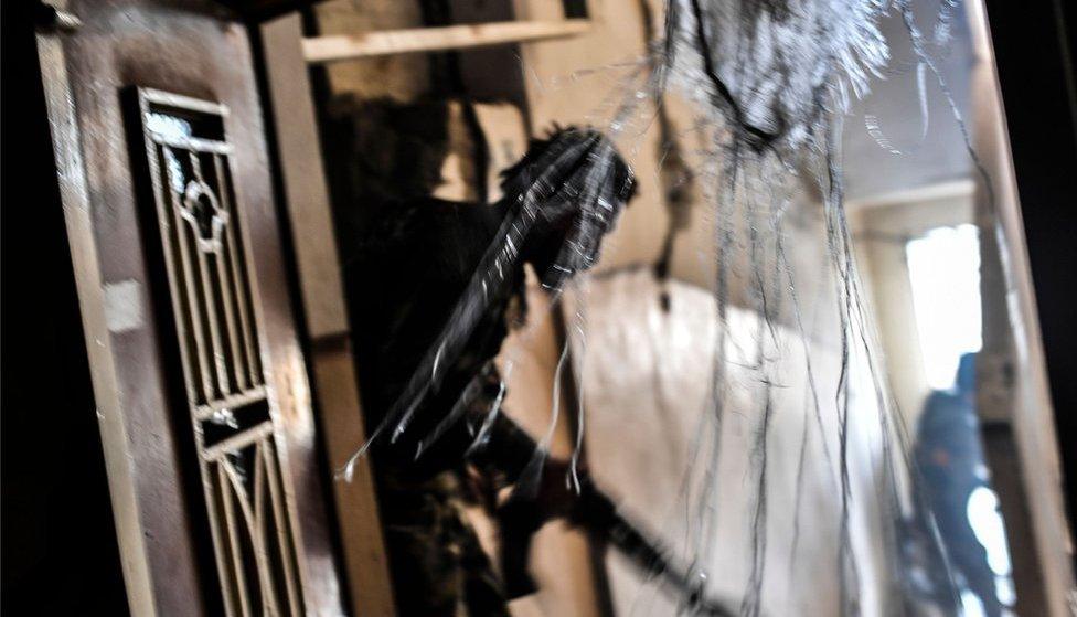 Members of the Syrian Democratic Forces patrol a damaged house in Raqqa in September, 2017