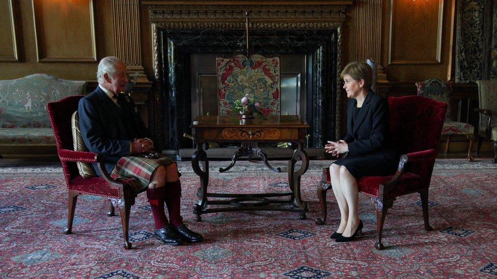 King Charles sits with First Minister Nicola Sturgeon during an audience at the Palace of Holyroodhouse