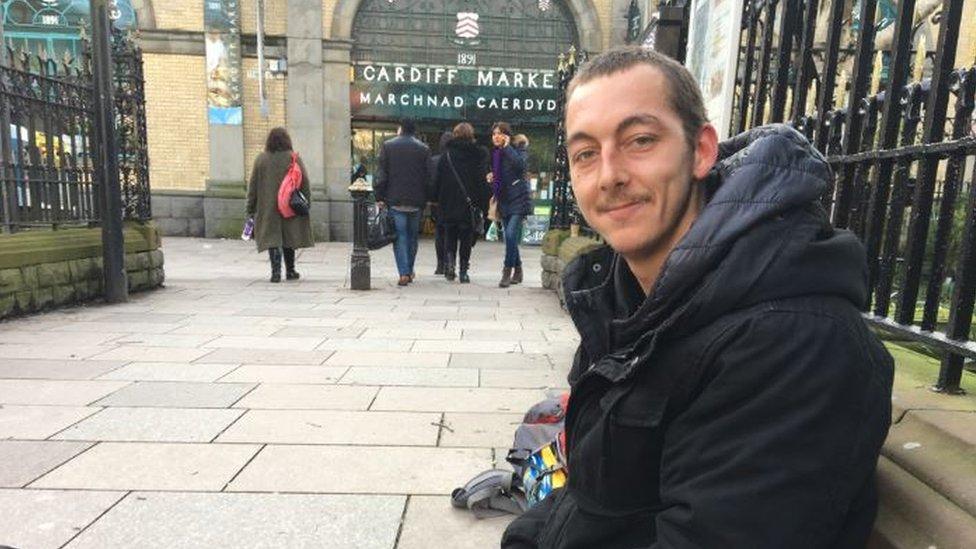 Troy sitting on the street in Cardiff