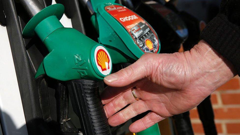 Man reaching for a fuel pump