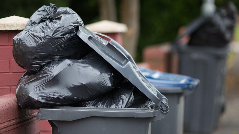 Overflowing wheelie bin