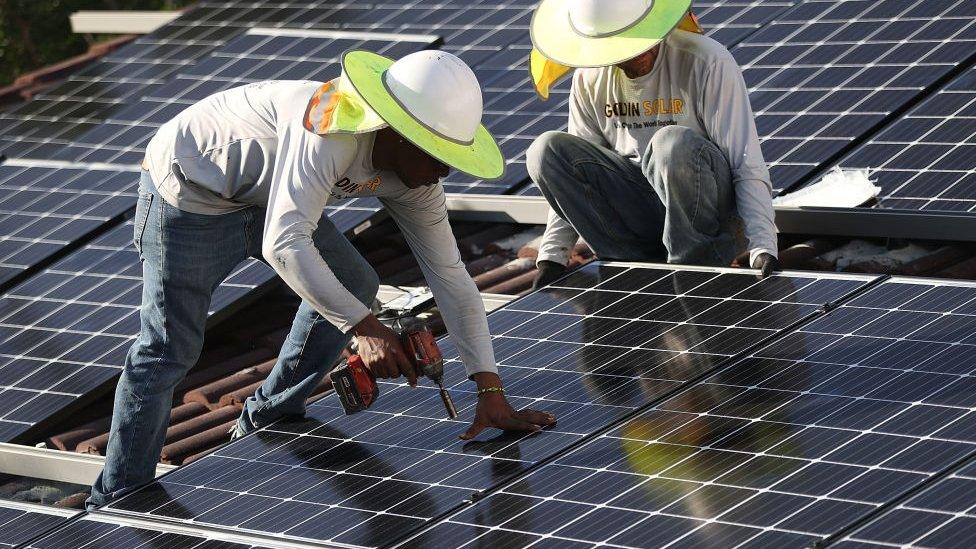 Person installing solar panels