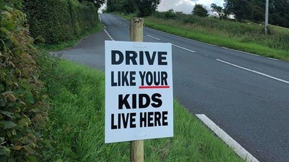 sign warning about speed