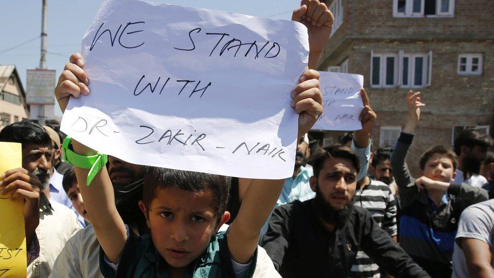 Kashmiri Muslims hold placards and shout slogans during a protest in favour of Islamic scholar and Peace TV founder, Dr. Zakir Naik in Srinagar, the summer capital of Indian Kashmir, 08 July 2016.