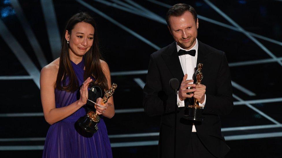 British producer Joanna Natasegara and British director Orlando von Einsiedel stand on stage after they won the Best Documentary Short award for The White Helmets