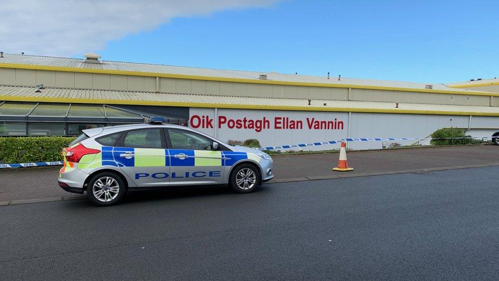 Police car and cordon at post office sorting office