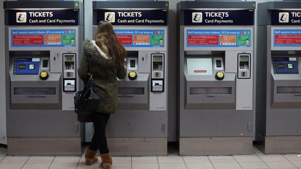 Woman buying rail ticket