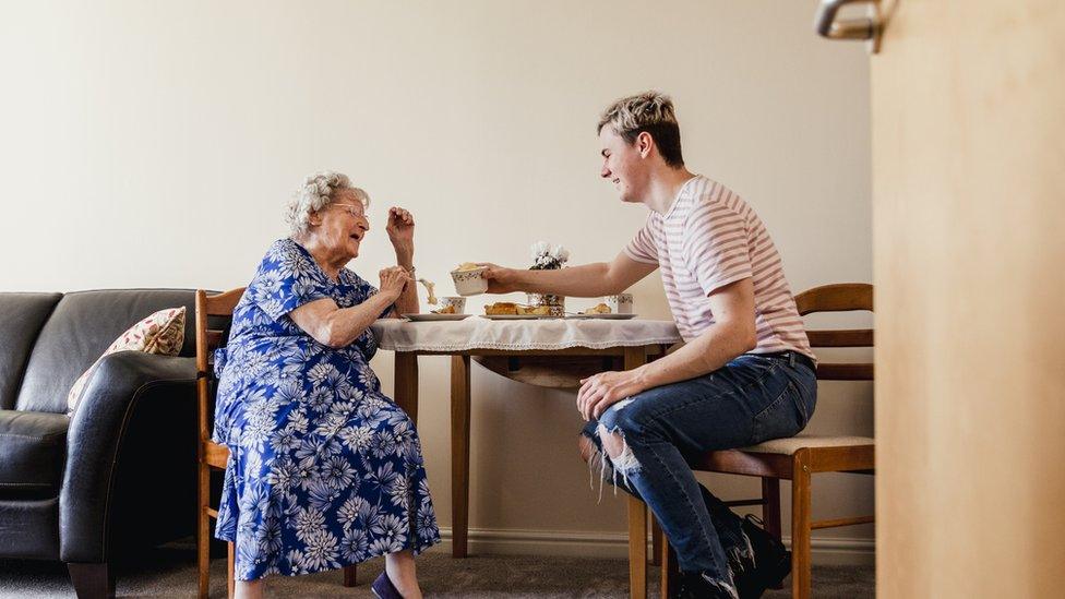 Young man visiting elderly relative