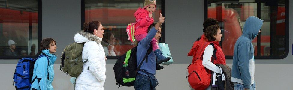 Migrants walk on a platform after their arrival at the main railway station in Munich, southern Germany, on 6 September 2015