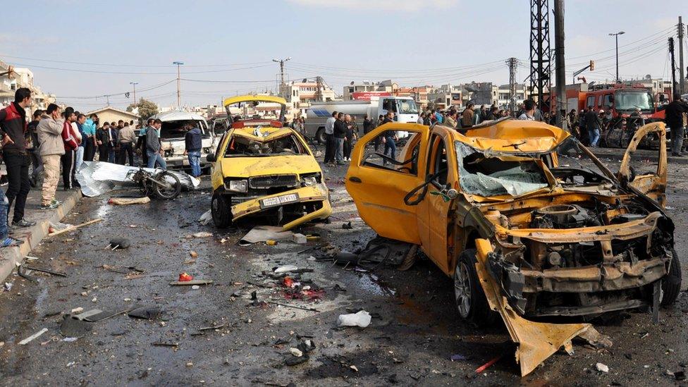 Wrecked cars in Homs, Syria following a double car bombing