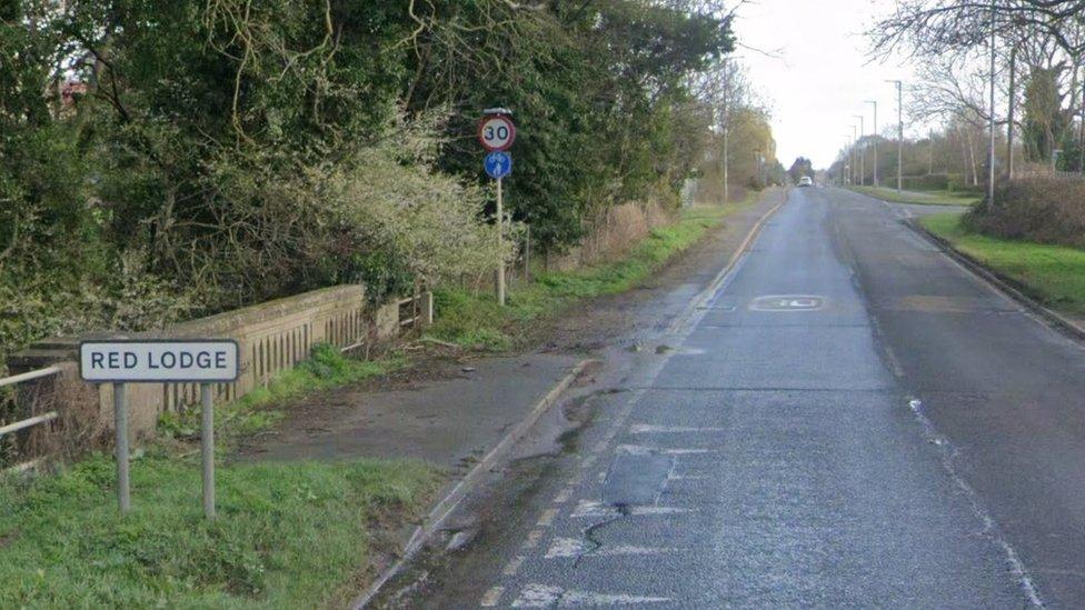 The road leading into Red Lodge with the village sign