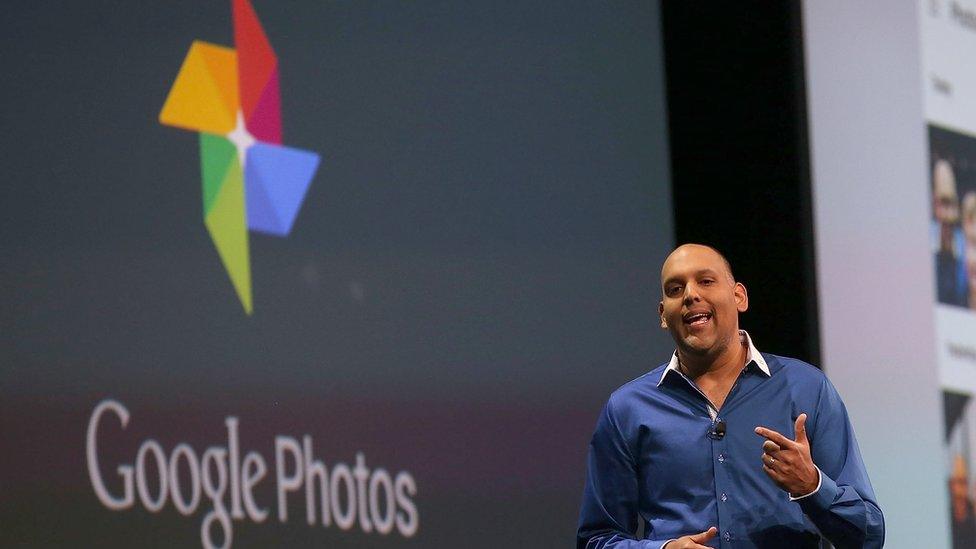 Anil Sabharwal stands on stage announcing Google Photos in May 2018