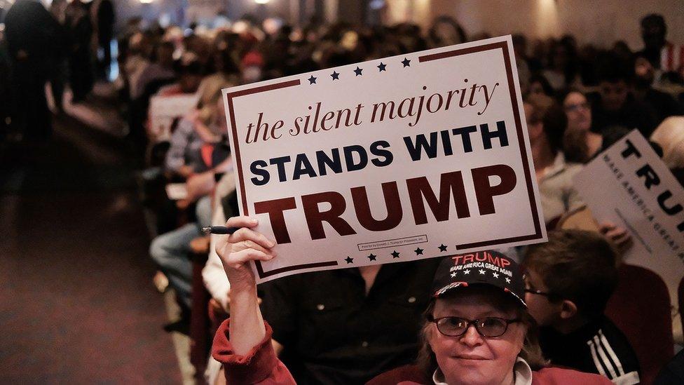 Woman holding Trump poster