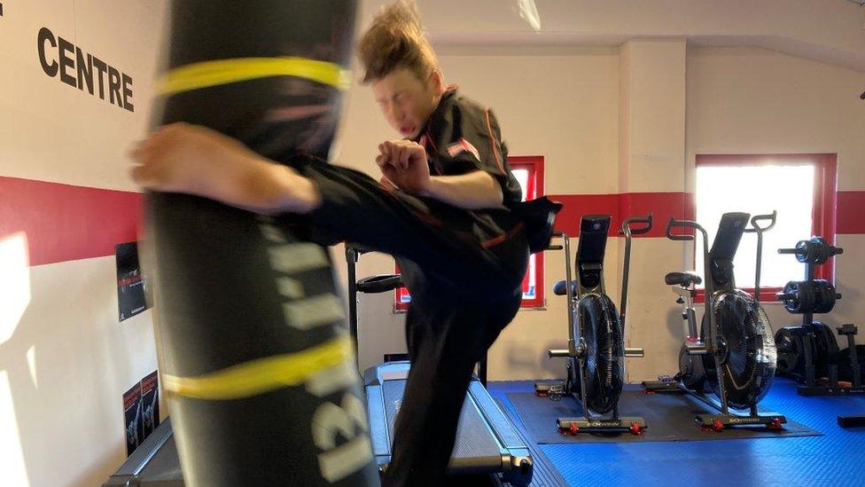 Gerard Knight kicking a punchbag