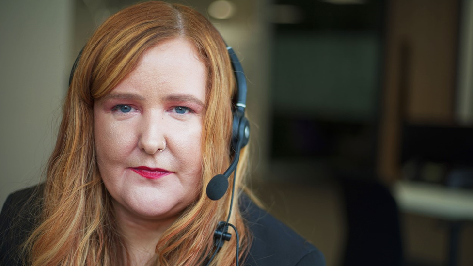 Debt adviser Lynsey Muff wearing headphones with a microphone