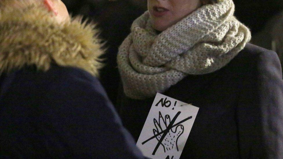 Women protest against sexism outside the cathedral in Cologne, Germany