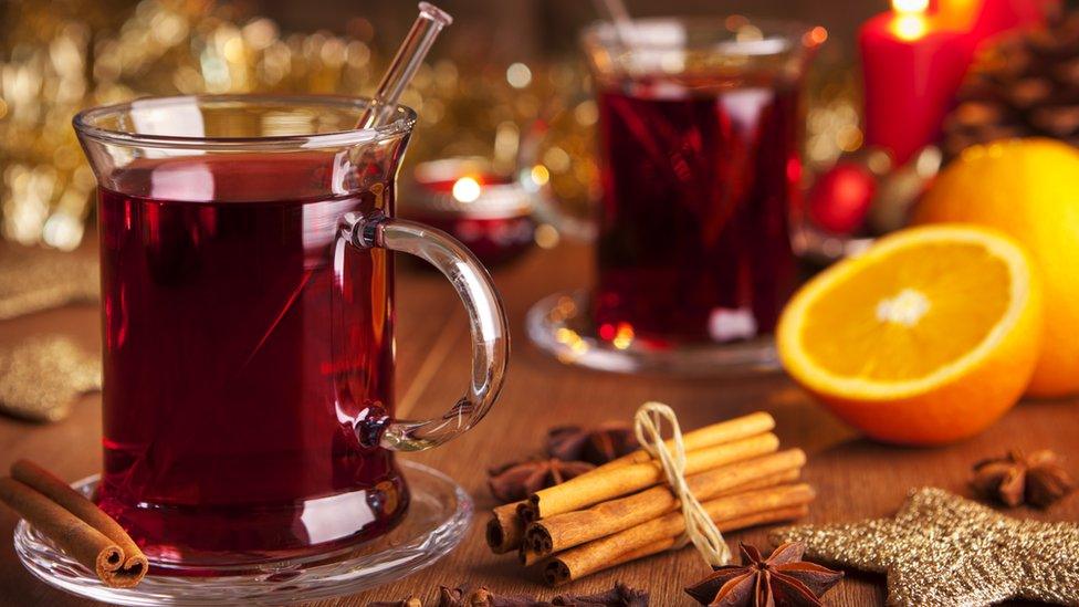 Mulled wine, orange half and cinnamon sticks