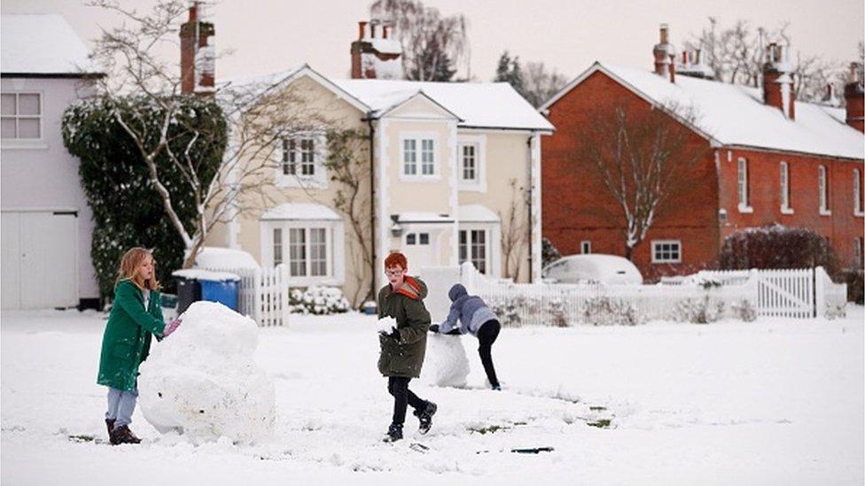 Children play in the snow in Hartley Wintney,