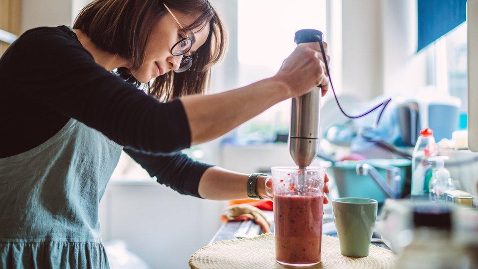 Woman making a smoothie