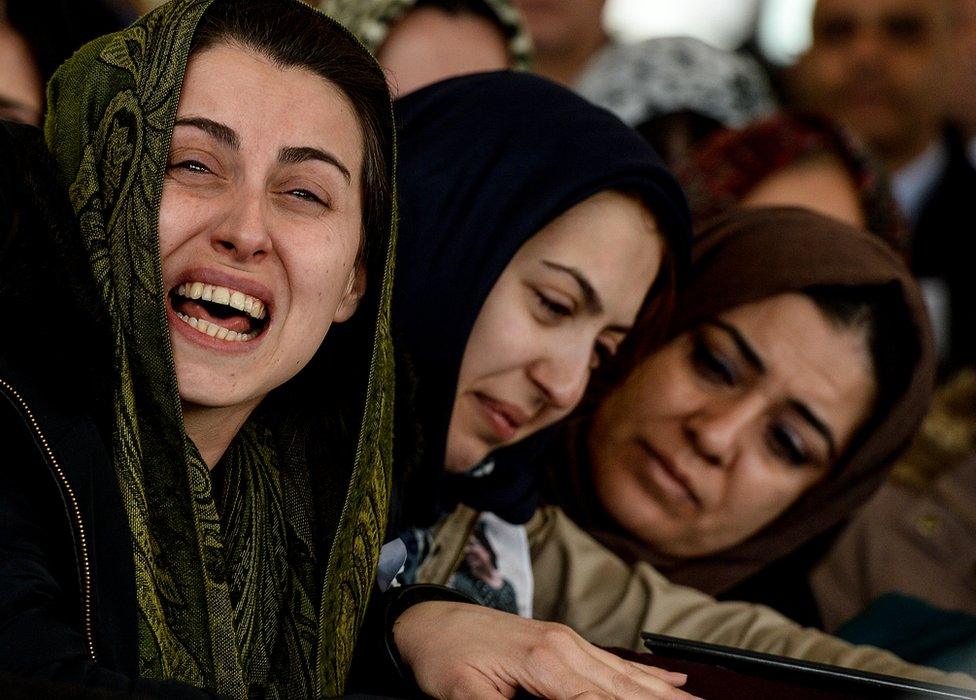 Women mourn over the coffin of one of the victim's of Sunday's bombing in Ankara