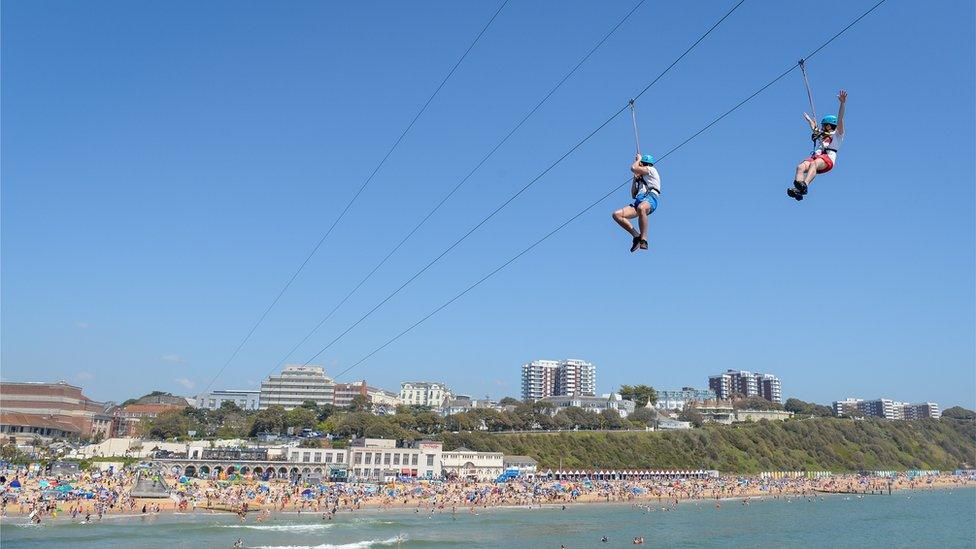 People enjoy the zip line ride on the beach at Bournemouth beach on Bank Holiday Monday