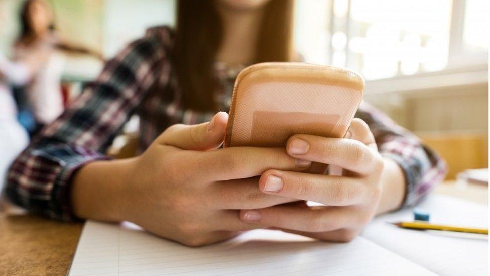 Teenage using mobile phone