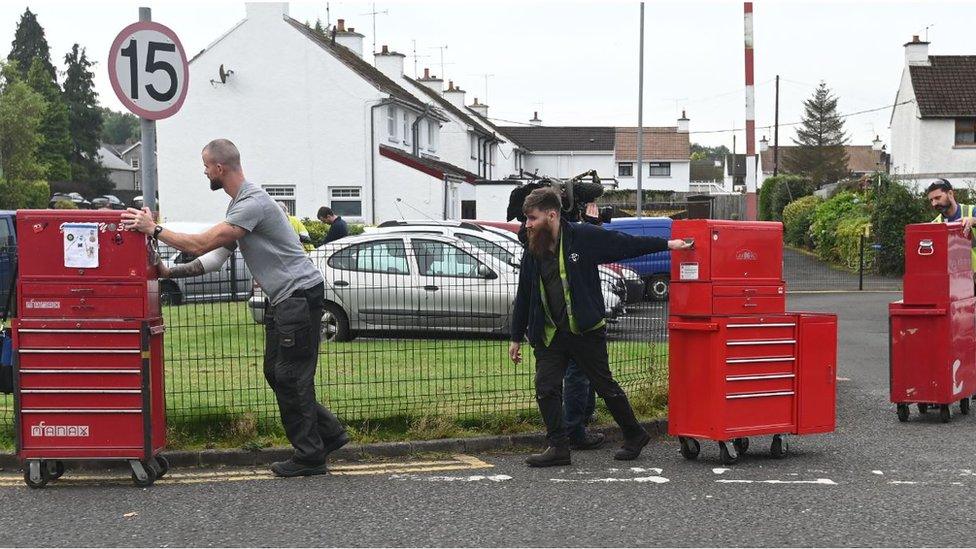 Workers pushing containers