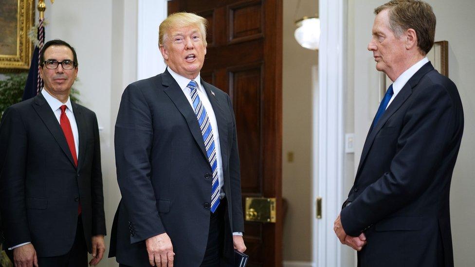 US President Donald Trump answers a reporter's question after signing the Section 232 proclamations on steel and aluminum imports in the Roosevelt Room of the White House on March 8, 2018 in Washington, DC.