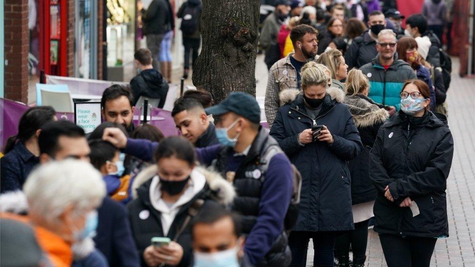 Hundreds of people queue at a vaccination centre on Solihull High Street, West Midlands