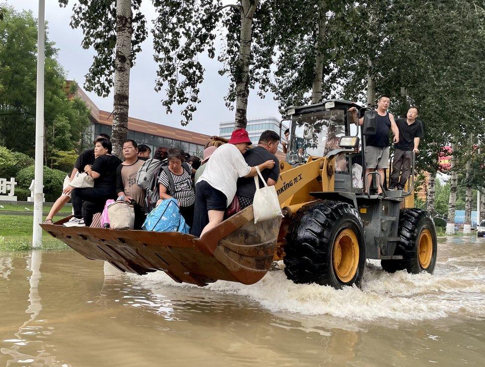 Residents rescued on a bulldozer