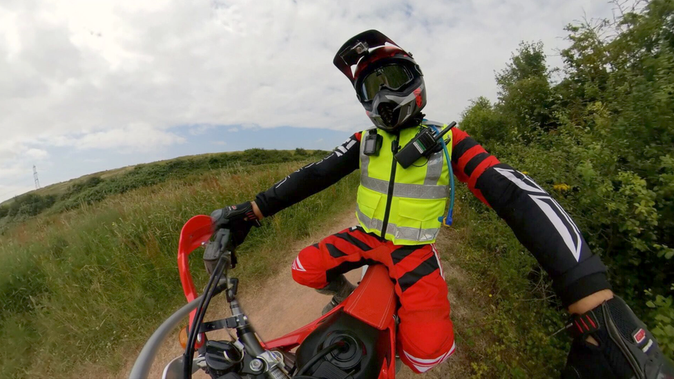 A member of Operation Red Mana on an off-road bike