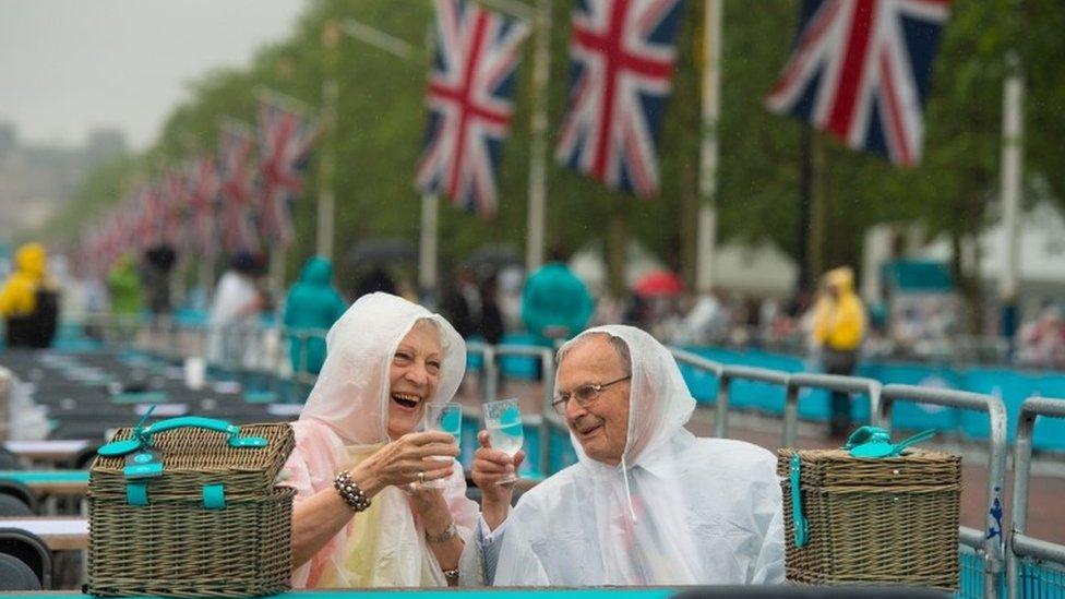 People braving the rain on The Mall