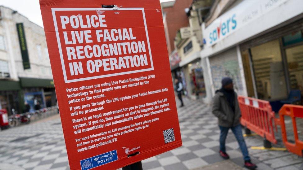 Red sign stating live facial recognition technology was in operation