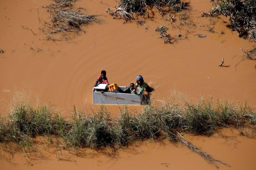 A child is transported on a fridge during floods after Cyclone Idai, in Buzi, outside Beira, Mozambique, 21 March 2019.