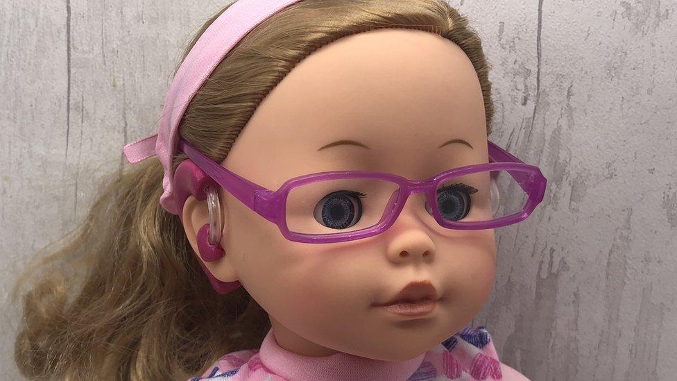 Doll with glasses and hearing aid