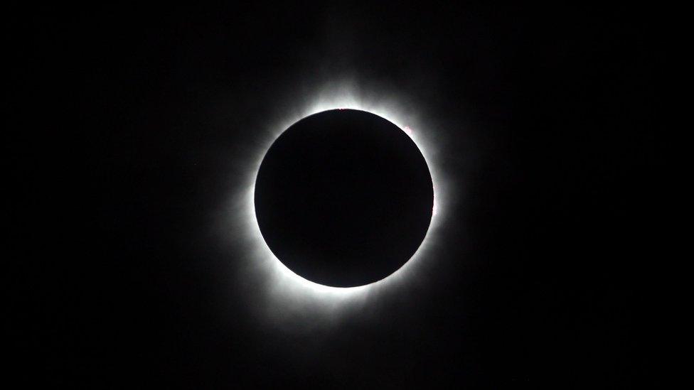 The sun is seen in full eclipse over a park on August 21, 2017 in Hiawatha, Kansas