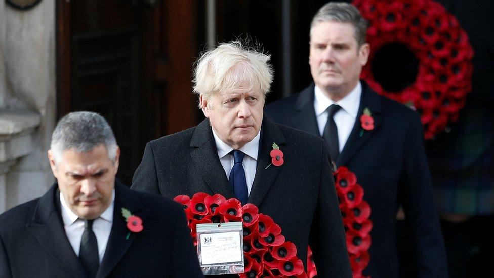 Prime Minister Boris Johnson carries a poppy wreath during a National Service of Remembrance at the Cenotaph in Westminster