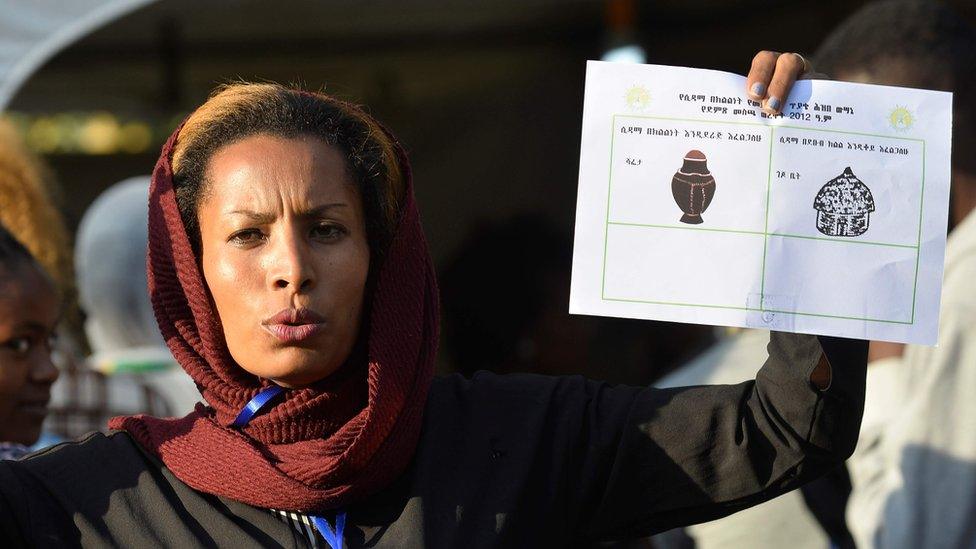 Woman showing ballot paper