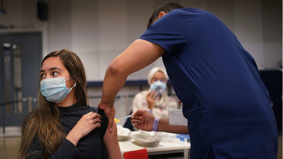 A woman being vaccinated at Tottenham's stadium in north London