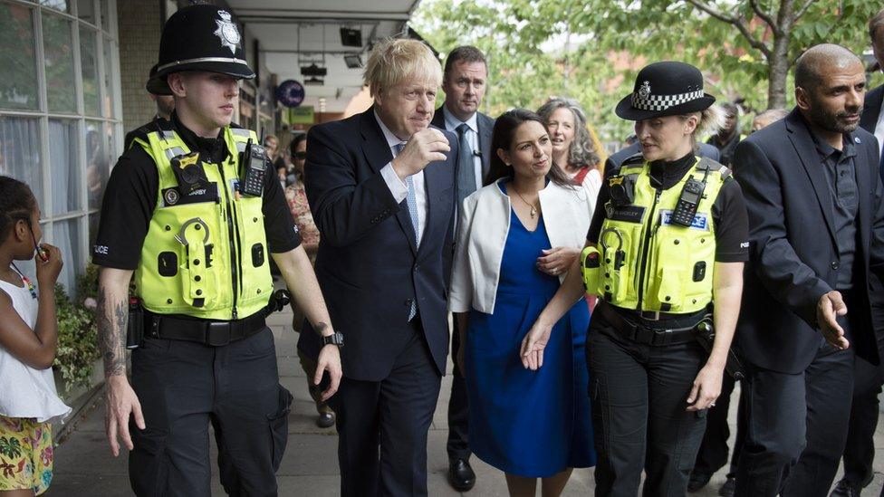 Prime Minister Boris Johnson and Home Secretary Priti Patel on a walkabout with local police during a visit to North Road, Harbourne, Birmingham