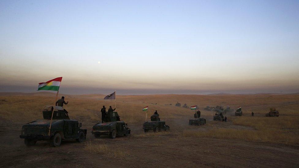 Monday, Oct. 17, 2016 file photo, a Peshmerga convoy drives towards a frontline in Khazer, about 30 kilometers (19 miles) east of Mosul, Iraq.