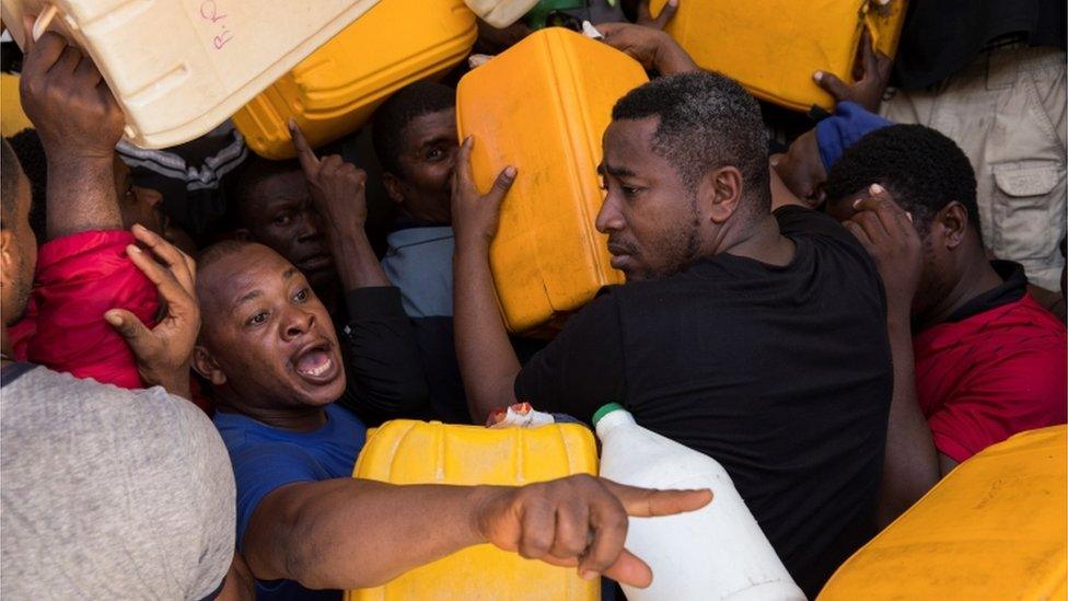 People try to get gasoline at a station in Port-au-Prince, Haiti, 04 November 2021.