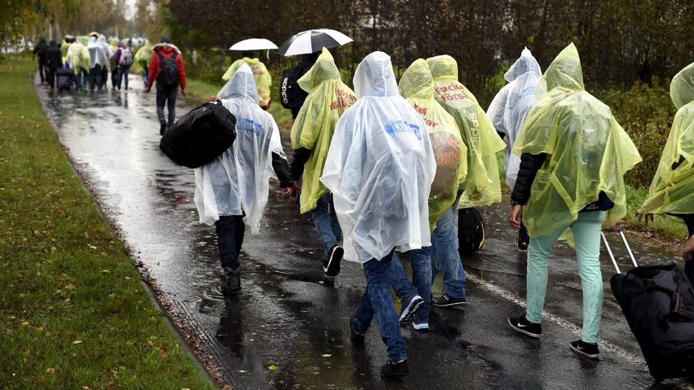 Refugees walk from a public transport centre to a reception centre in Tornio, north-west Finland, September 2015.