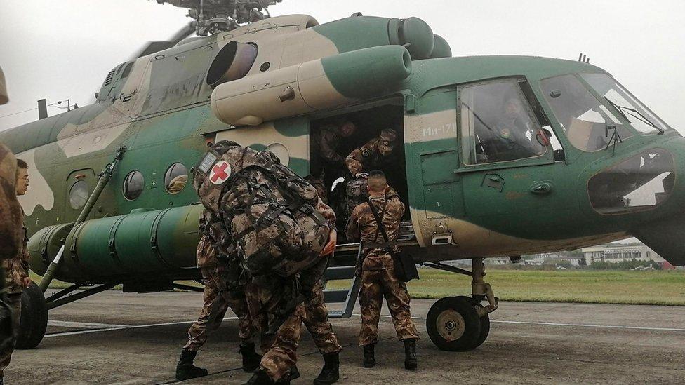 Chinese soldiers board a helicopter in Chengdu in Sichuan province on April 1, 2019, as they prepare to rescue firefighters trapped by a forest blaze in Muli county