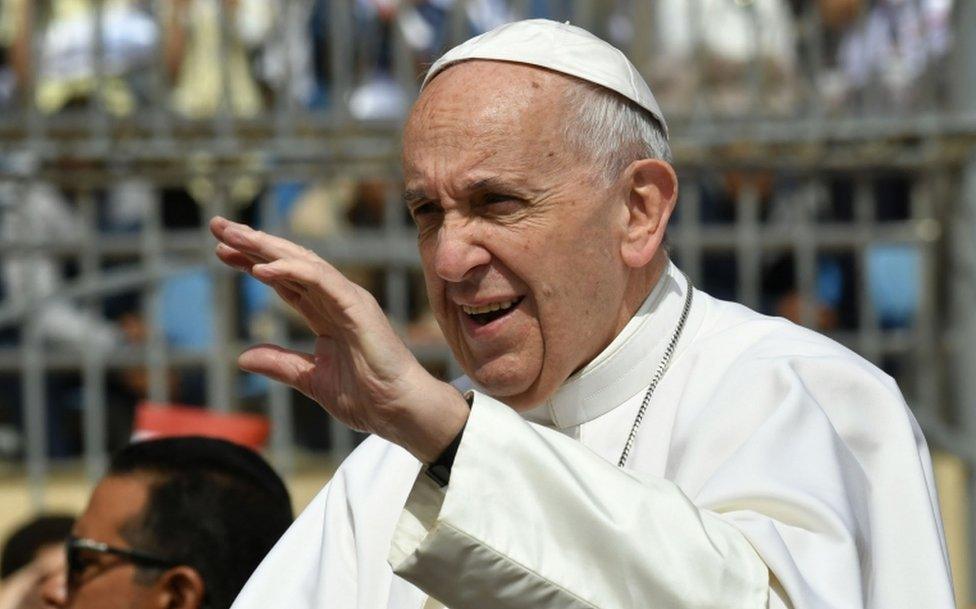 Pope Francis waves to worshippers before the start of a mass on April 29, 2017 at a stadium in Cairo.