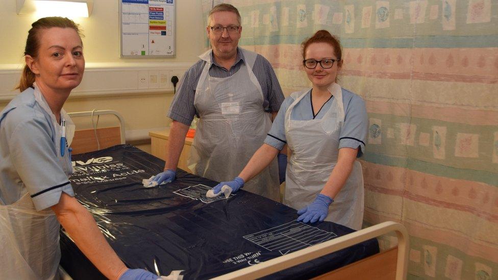 NHS Lanarkshire board secretary Paul Cannon helps ward staff