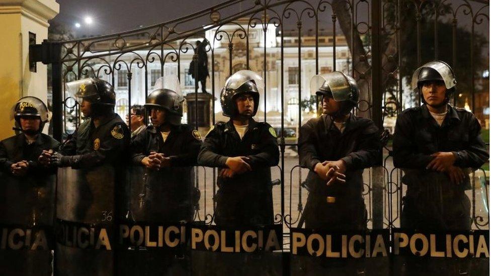 Police stand guard outside the Congress building