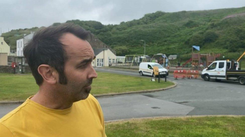 Resident Andrew Barton looking towards the damage